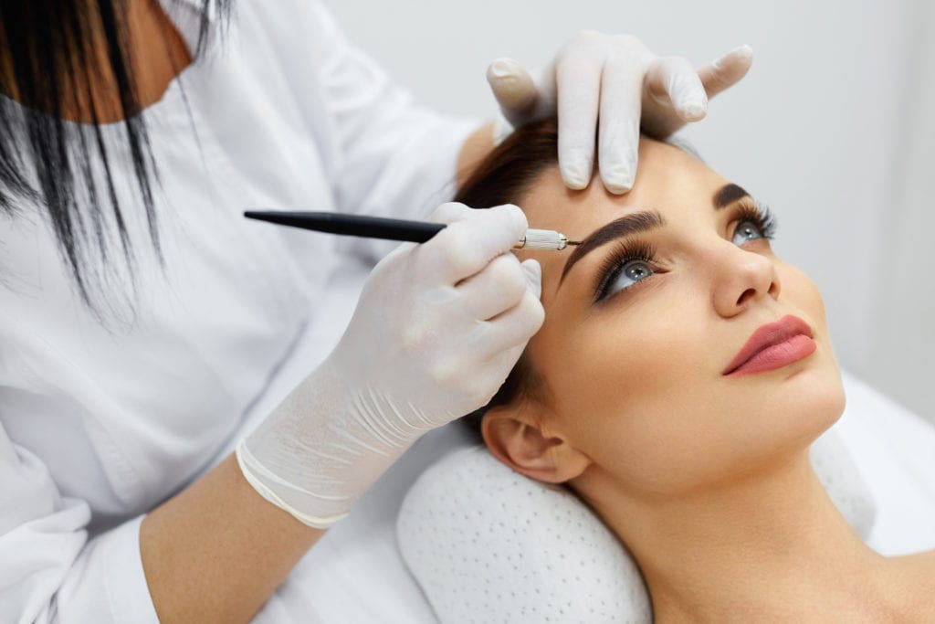 Beautiful woman getting eyebrow treatment | Get Skincare treatment at Flutter and Wink in Vancouver, Washington