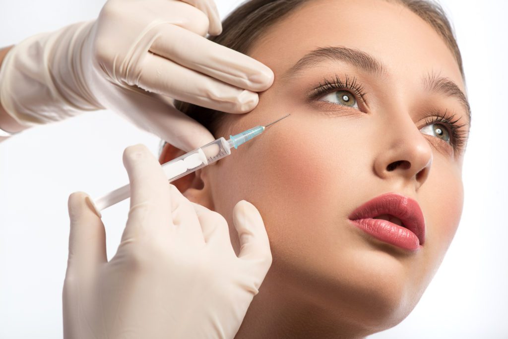 Young and Pretty lady getting the injection to her below eyes | Get Botox at Flutter and Wink in Vancouver, Washington